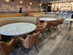 Tan faux leather restaurant seating with fabric back