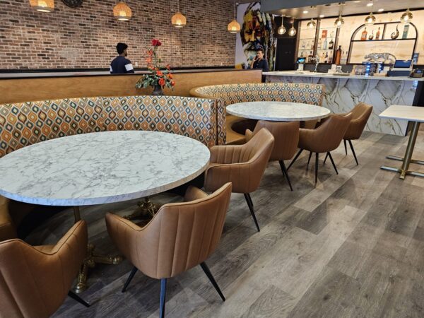 Tan faux leather restaurant seating with fabric back