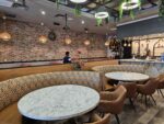 Tan faux leather restaurant seating with fabric back