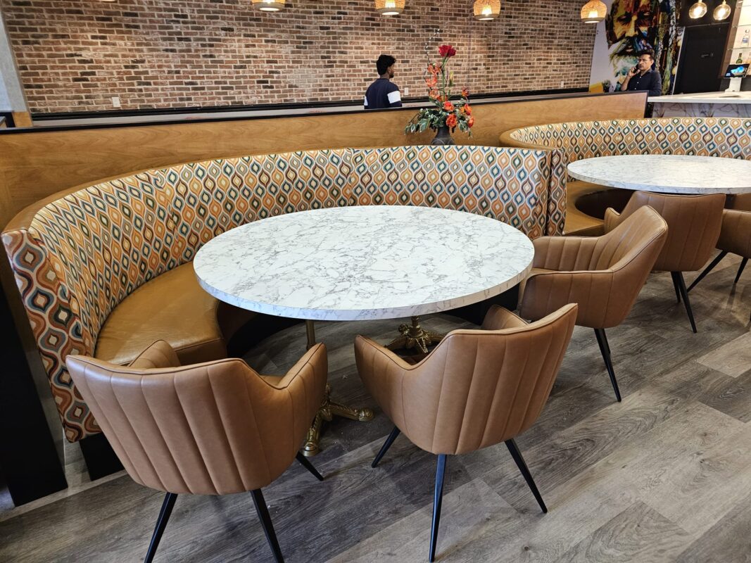 Tan faux leather restaurant seating with fabric back